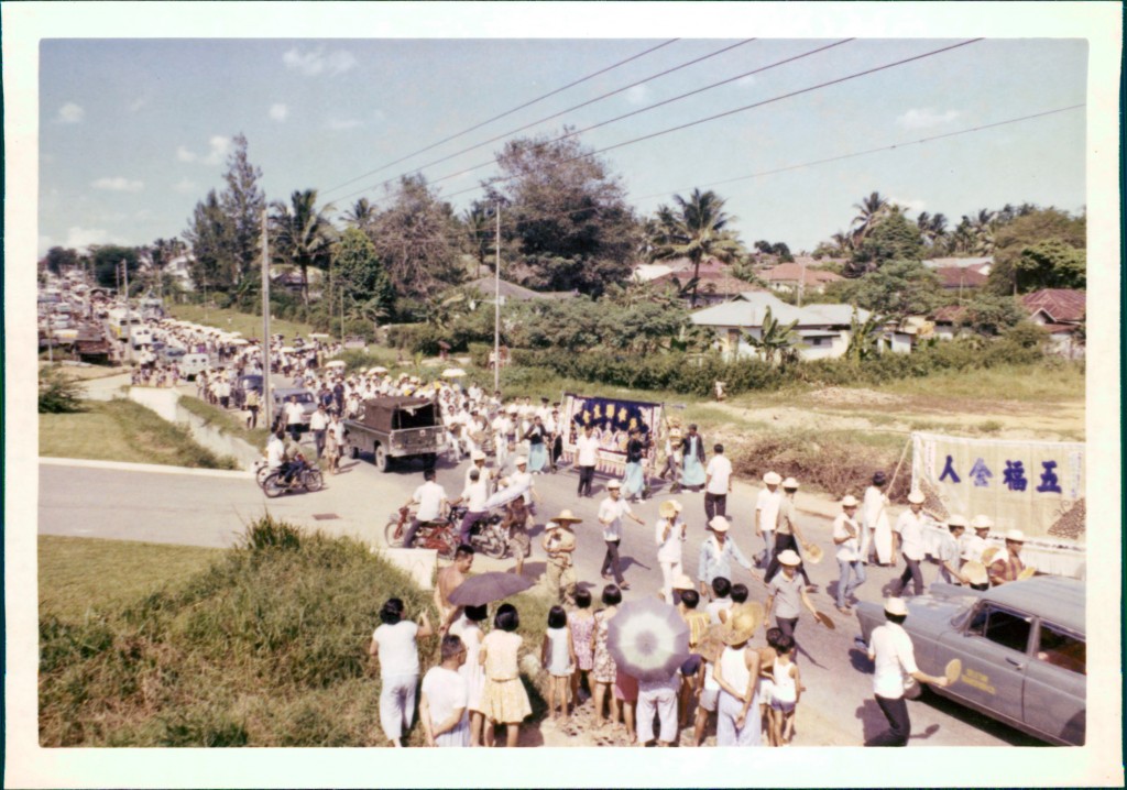 Funeral procession through the village, as curious bystanders look on. Photo: Teo Yap Tee